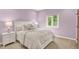 Bedroom with neutral carpet, a white bed frame, a bedside table, and a large window with tree views at 3862 Penzance Pl, Carmel, IN 46032