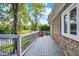 Inviting deck with grey wood, brick exterior and peaceful views of the backyard pond, perfect for relaxation at 3862 Penzance Pl, Carmel, IN 46032