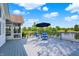 Spacious deck features seating and an umbrella overlooking a tranquil pond, creating a relaxing outdoor experience at 3862 Penzance Pl, Carmel, IN 46032