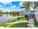 Inviting backyard deck with stairs leading down to the pond and lawn with beautiful outdoor scenery at 3862 Penzance Pl, Carmel, IN 46032
