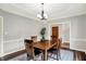 Traditional dining room featuring wood floors, a wooden table and natural lighting at 3862 Penzance Pl, Carmel, IN 46032