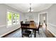 Cozy dining room with natural light, wood table set, and a classic rug at 3862 Penzance Pl, Carmel, IN 46032