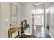 Bright foyer with elegant decor and hardwood flooring, leading to the rest of the home at 3862 Penzance Pl, Carmel, IN 46032