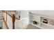 A naturally lit hallway with built in shelving and a classic, wooden railing at 3862 Penzance Pl, Carmel, IN 46032