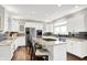 Bright kitchen with stainless steel appliances, tile backsplash, and granite countertops at 3862 Penzance Pl, Carmel, IN 46032