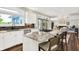 Bright kitchen with stainless steel appliances, granite countertops, and seating at the island at 3862 Penzance Pl, Carmel, IN 46032
