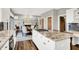 Bright kitchen with stainless steel appliances, granite countertops, and island cooktop at 3862 Penzance Pl, Carmel, IN 46032