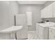 Laundry room featuring a washer, dryer, refrigerator and a folding table at 3862 Penzance Pl, Carmel, IN 46032