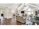 Open living room with fireplace, cathedral ceilings, lots of light, and hardwood floors at 3862 Penzance Pl, Carmel, IN 46032