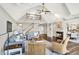 Bright living room with vaulted ceilings, fireplace, hardwood floors, and a staircase to a second-floor landing at 3862 Penzance Pl, Carmel, IN 46032