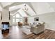 Large living room features fireplace, vaulted ceilings, natural light, and hardwood flooring at 3862 Penzance Pl, Carmel, IN 46032
