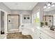 Main bathroom with separate shower, jetted tub, and vanity with plenty of storage at 3862 Penzance Pl, Carmel, IN 46032
