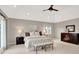 Bedroom features a king bed, neutral carpet, ceiling fan, and large window with natural light at 3862 Penzance Pl, Carmel, IN 46032