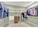 Spacious walk-in closet with custom shelving for organization and storage of clothes, shoes, and accessories at 3862 Penzance Pl, Carmel, IN 46032