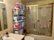 Bathroom features glass enclosed bathtub with shower head, toilet, and lots of extra TP at 3934 N Lakeside Dr, Muncie, IN 47304