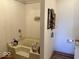 Bathroom with a bathtub, tiled walls, vanity, and framed pictures at 3934 N Lakeside Dr, Muncie, IN 47304