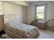 Bedroom features a large bed with quilt, a side table, and ample natural light at 3934 N Lakeside Dr, Muncie, IN 47304