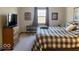 Comfortable bedroom with cozy blankets, a dresser, and natural light from the window at 3934 N Lakeside Dr, Muncie, IN 47304