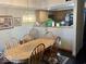 Inviting dining area with a wooden table, chairs, and a view into the kitchen, perfect for entertaining at 3934 N Lakeside Dr, Muncie, IN 47304