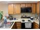 Kitchen featuring appliances, counter space, and wood cabinets, great for cooking and storage at 3934 N Lakeside Dr, Muncie, IN 47304