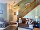 Comfortable living room with a staircase and cozy seating arrangement, perfect for Gathering time at 3934 N Lakeside Dr, Muncie, IN 47304
