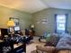 Living room features a desk, a twin bed, and a cozy couch at 3934 N Lakeside Dr, Muncie, IN 47304