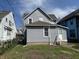 View of the home's backyard with green grass and side entrance to the home at 418 N Drexel Ave, Indianapolis, IN 46201