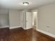 Bedroom featuring hardwood floors and a view of another room through a doorway at 418 N Drexel Ave, Indianapolis, IN 46201