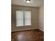 Carpeted room with a window, white trim, and a simple light fixture at 418 N Drexel Ave, Indianapolis, IN 46201