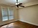 Bedroom featuring hardwood floors, a ceiling fan, and a large window with blinds at 418 N Drexel Ave, Indianapolis, IN 46201