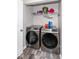 Laundry room features modern washer and dryer units with shelving for storage in a practical space at 4414 Lexington Ave, Indianapolis, IN 46203