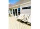 Inviting back deck, ideal for entertaining, featuring comfortable, covered seating and convenient access to the house through glass doors at 4414 Princeton Park Dr, Columbus, IN 47201