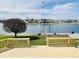 Enjoy the serene lake view from this backyard deck, complete with seating and well-manicured lawn at 4414 Princeton Park Dr, Columbus, IN 47201