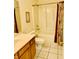 Bathroom features a bathtub and shower combination with curtain, a sink, and toilet at 4414 Princeton Park Dr, Columbus, IN 47201