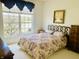 Comfortable bedroom with bright natural light and floral-patterned bedding at 4414 Princeton Park Dr, Columbus, IN 47201