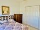 Bedroom view featuring decorative artwork, a patterned comforter, and closet at 4414 Princeton Park Dr, Columbus, IN 47201