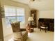 Bright bedroom featuring vaulted ceilings, a relaxing chair near the window, and classic wood furniture at 4414 Princeton Park Dr, Columbus, IN 47201