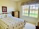 Relaxing bedroom view with large windows and floral patterned bedding at 4414 Princeton Park Dr, Columbus, IN 47201