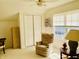 Bright bedroom featuring vaulted ceilings, a relaxing chair near the window, and closet storage at 4414 Princeton Park Dr, Columbus, IN 47201