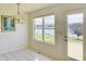 Charming dining area with lake views, chandelier, and sliding glass door to the deck at 4414 Princeton Park Dr, Columbus, IN 47201