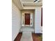 Well-lit front entrance with red door, sidelights, and a concrete porch at 4414 Princeton Park Dr, Columbus, IN 47201