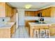 Spacious kitchen featuring wood cabinets, a breakfast bar, and modern appliances at 4414 Princeton Park Dr, Columbus, IN 47201