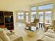 Bright living room featuring large windows overlooking a serene lake view at 4414 Princeton Park Dr, Columbus, IN 47201