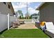 Fenced in back yard features brick patio and outdoor furniture at 4850 Guilford Ave, Indianapolis, IN 46205