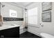 Well-lit bathroom with white subway tile walls, dark flooring, and modern fixtures at 4850 Guilford Ave, Indianapolis, IN 46205