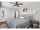 Calming bedroom with neutral decor, a ceiling fan, and natural light from the windows at 4850 Guilford Ave, Indianapolis, IN 46205