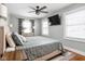 Comfortable bedroom featuring a ceiling fan, large windows, and neutral-toned decor at 4850 Guilford Ave, Indianapolis, IN 46205