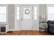 Bright entryway featuring a decorative door with sidelights and hardwood flooring at 4850 Guilford Ave, Indianapolis, IN 46205