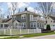 Attractive home exterior featuring a fenced yard and second story balcony at 4850 Guilford Ave, Indianapolis, IN 46205