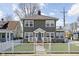 Inviting home with a well-manicured lawn, fenced yard, and an appealing front porch at 4850 Guilford Ave, Indianapolis, IN 46205